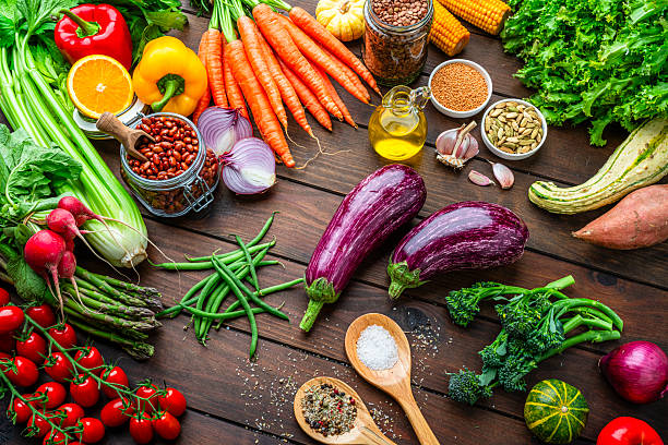 istock Fresh organic vegetables on kitchen table. Preparing healthy vegetarian meal, kitchen table filled with freshly picked. Food to improve the inmune system. Spices legumes and cooking oil 2247485868
