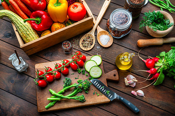 istock High angle view of a kitchen table, cutting board, vegetables and spices. Cooking healthy vegetarian food. Raw food diet for healthy lifestyle 2247486106