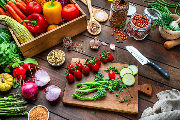 istock Cutting board, vegetables and spices. Kitchen table filled with fresh organic produce. Healthy raw food diet, low calories meal, dieting, self caring lifestyle 2247486120
