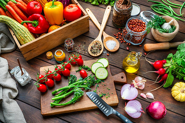 istock Cutting board, vegetables and spices. Kitchen table filled with fresh organic produce. Healthy raw food diet, low calories meal, dieting, self caring lifestyle 2247486134