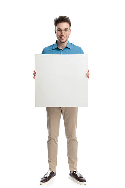istock Happy casual man with glasses holding blank billboard 2247488044