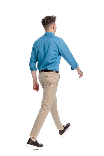 istock Back view of casual man with glasses walking 2247488089