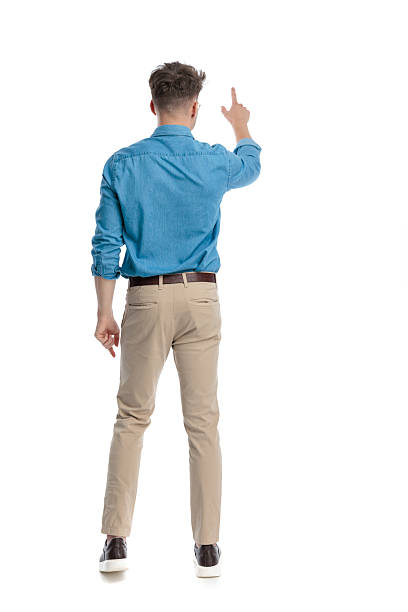 istock Back view of casual man standing and pointing up 2247488137