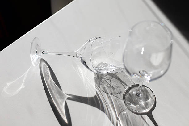 istock broken wine glass next to a whole one minimalism white background with shadows 2247488249