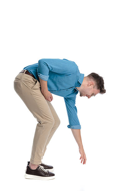 istock Happy casual man bending over and reaching down 2247488250