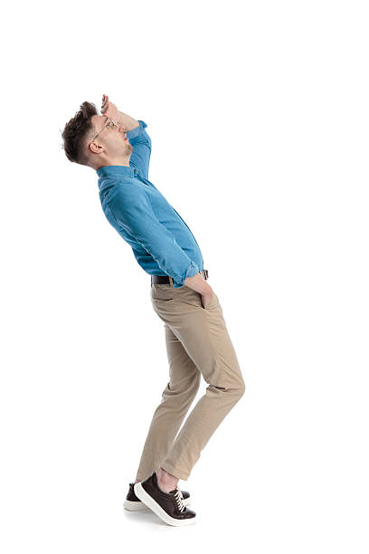 istock Side view of man shielding eyes and looking up 2247488257