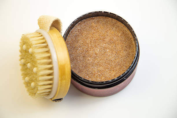 istock Natural body scrub in a round container with a wooden brush, showcasing a rich texture and inviting aroma, perfect for skincare and self-care routines 2247488549
