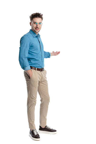istock Happy casual man standing and presenting to side 2247488585