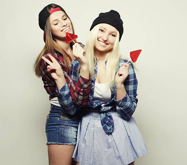 best friends teenage girls together having fun, posing emotional on white background, besties happy smiling, lifestyle people concept, blond and brunette multi nations close up