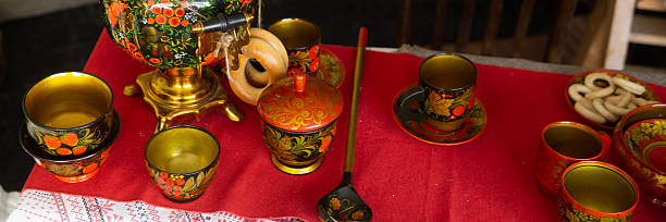 istock Traditional Khokhloma folk craft table setting with samovar, spoons, and snacks. Russian tea drinking food and decorative tableware for cultural design background. 2247492779