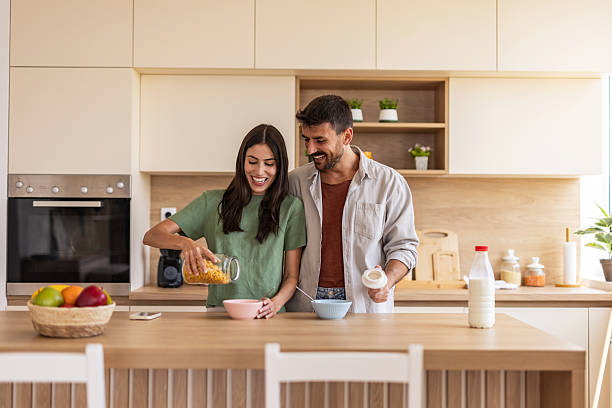 istock Happy couple preparing breakfast cereal in kitchen 2247497398
