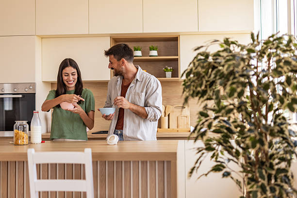 istock Happy couple eating breakfast cereal in kitchen 2247497682