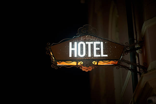 Dilapidated neon sign of a hotel in Riva del Garda at night