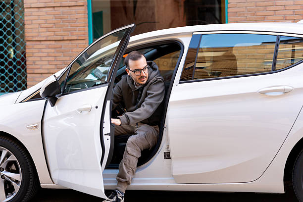istock Freelance programmer commuting, getting out of a white car 2247504489