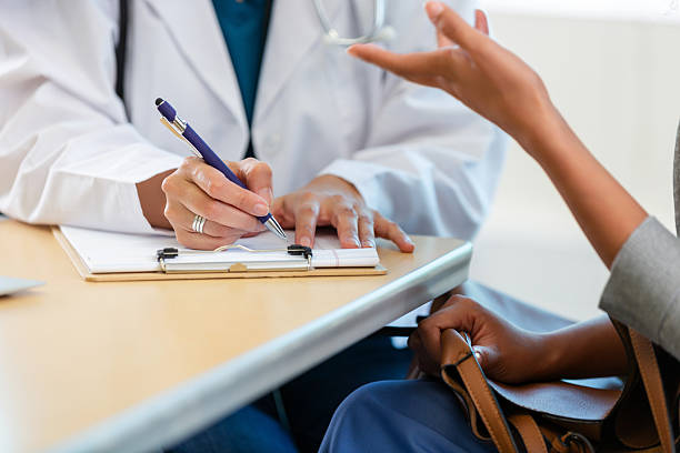 istock Doctor consults with patient, taking notes on a clipboard during medical examination. 2247506049