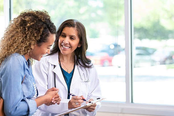 istock Doctor discusses health plan with patient while writing on clipboard, creating a supportive atmosphere. 2247506070