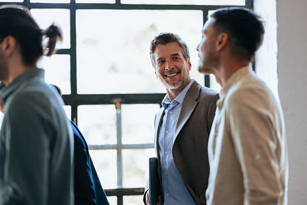 istock Smiling Business Team Members Engage In Conversation In Modern Office Setting 2247507160