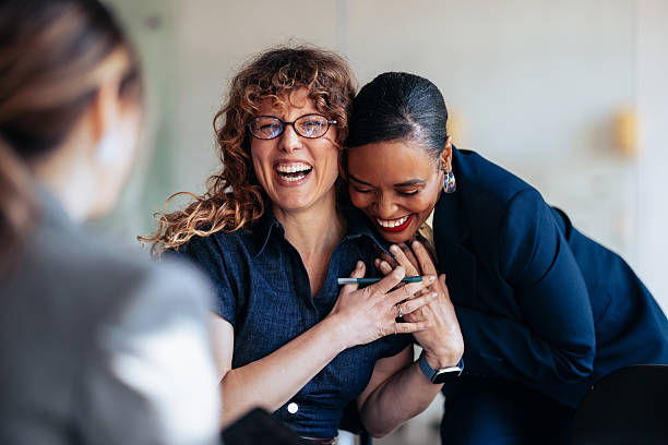 istock Joyful Office Moment: Friends And Colleagues Laughing Together In A Professional Setting 2247507204