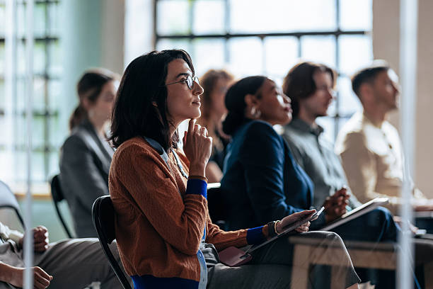istock Diverse Group Attentive Audience Attending Business Seminar in Modern Office Setting 2247507256