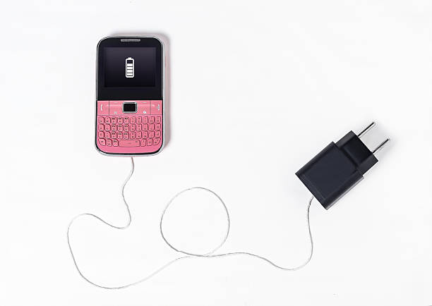 A vintage pink cell phone ironically depicted as a piece of string on a white background.