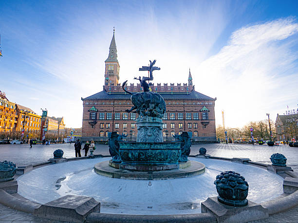 Copenhagen, Denmark – November 19, 2025: The Dragon Fountain stands in front of the red-brick City Hall on Rådhuspladsen, a central gathering space and transport hub.