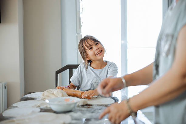 istock Grandma and granddaughter stretching dough 2247508840