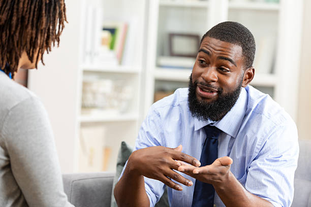 istock A man and a woman engaged in a deep conversation, possibly in a therapy session. 2247508972