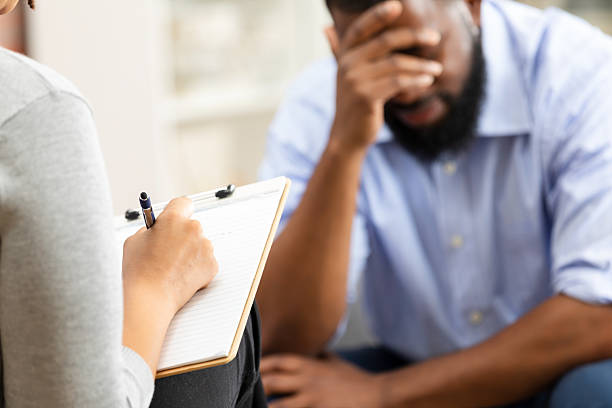 istock Patient speaking with mental health professional taking notes during counseling session 2247508981