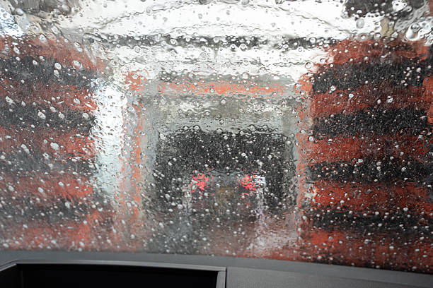 istock Front windscreen view of water droplets and brushes in an automatic car wash 2247509594