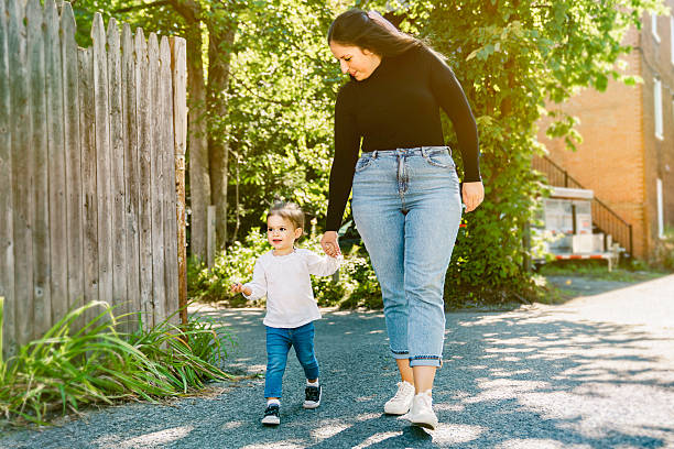 istock Young woman with cute two years old child outside 2247512264