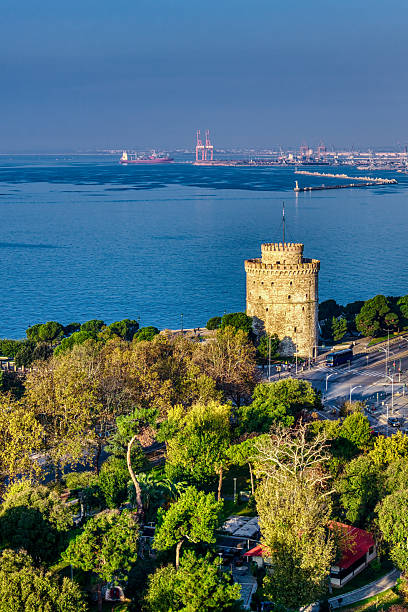 Thessaloniki stretches from green parks to the White Tower and the sea, an aerial glimpse of urban density, coastal rhythm, and layered history.
