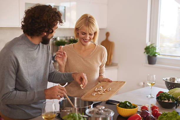 istock Young couple cooking together happy in kitchen 2247517856
