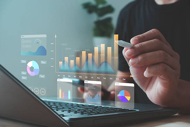 istock Businessman analyzing data and stock market visualization with digital charts, financial dashboards, and performance metrics. Ideal for investment analysis, trading strategy and economic forecasting. 2247520535