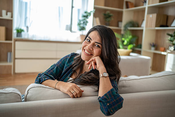 istock Happy woman smiling looking at camera relaxing at home 2247527601
