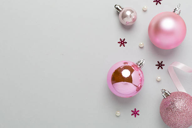 istock Pink christmas balls with decor on color background, top view 2247528302