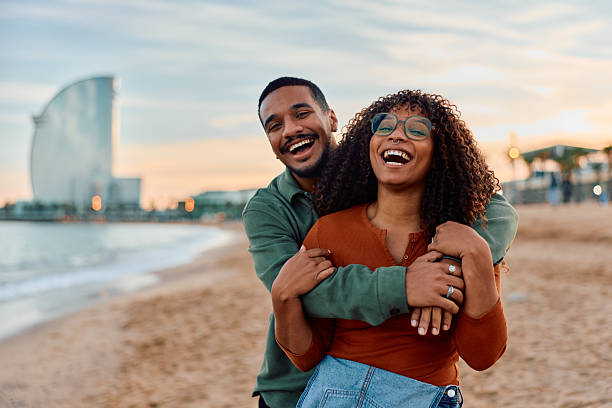 istock Happy couple embracing laughing on Barcelona beach at sunset 2247528770
