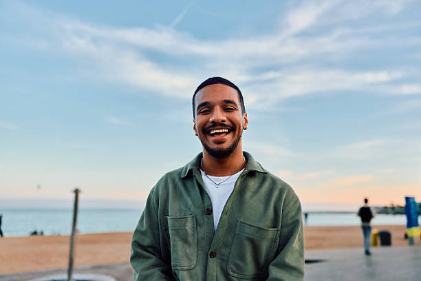 istock Happy young man smiling on Barcelona beach promenade 2247531338