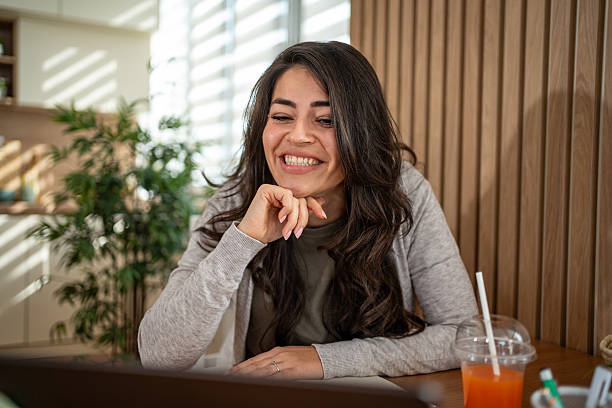 istock Woman smiling during video call using laptop remotely 2247532328