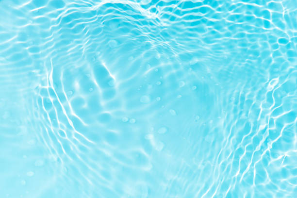 istock Blue water with ripples on the surface. Defocus blurred transparent blue colored clear calm water surface texture with splashes and bubbles. Water waves with shining pattern texture background. 2247532518