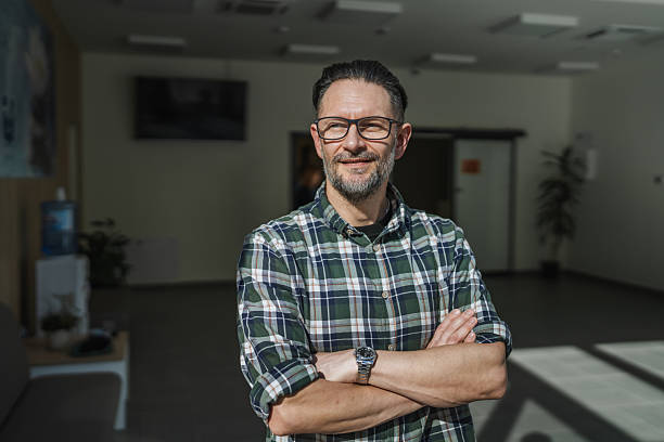 istock Confident man with beard and glasses smiling in an office 2247533843