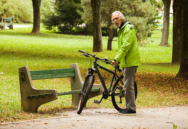 istock Happy active senior man cycling in the city 2247534229