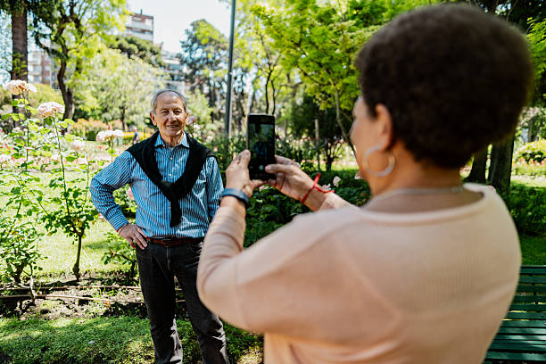 istock Senior man being photographed in a park 2247535922