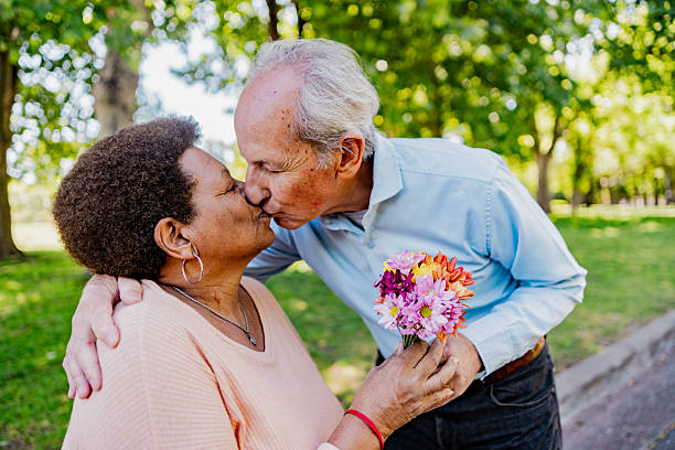 istock Loving senior couple sharing romantic moment in park 2247536544
