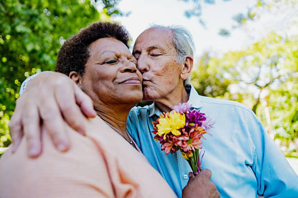 istock Loving senior couple sharing tender moment in park 2247537023