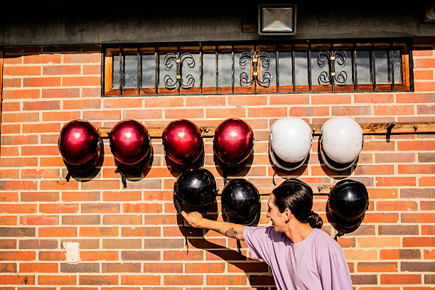 Young man choosing the right helmet for go-kart racing