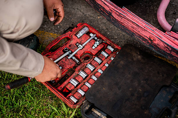 A detailed view of a well-organized red toolbox containing precision socket wrenches and mechanical tools, showcasing the essential equipment used by professional mechanics during repair and maintenance work.