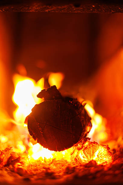Rustic fireplace fire background. Soft focus view of firewood burning in a rustic fireplace - warm glowing background for winter mood designs.