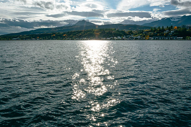 Sunset on the lake with mountains in the background in summer.