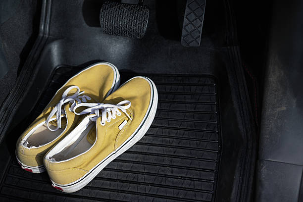 istock Shoes are under the car brakes. 2247539594
