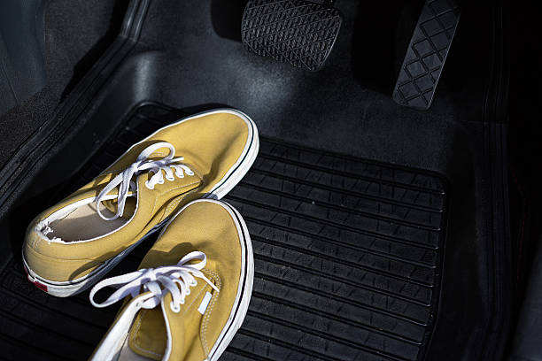 istock Shoes are under the car brakes. 2247539657